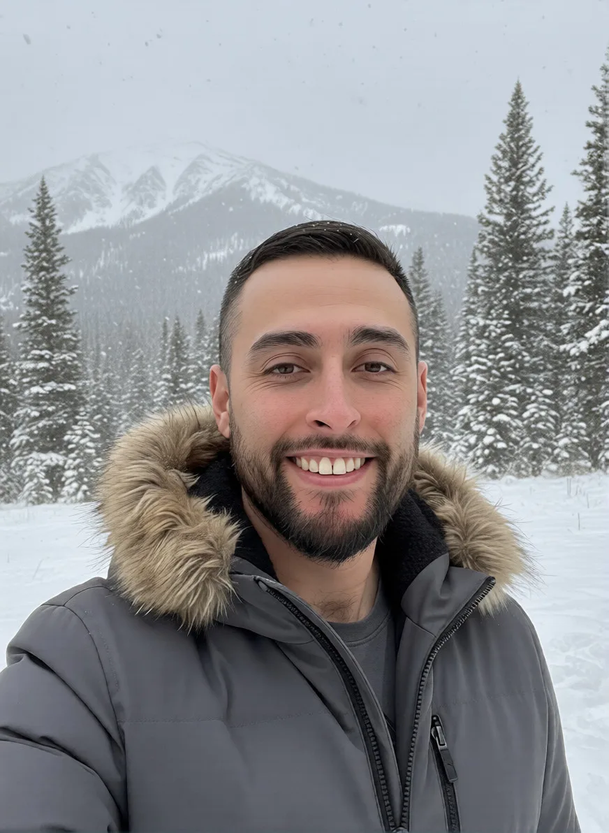 David Quintana in professional attire with a Colorado landscape behind him